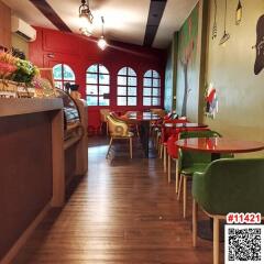 Cozy indoor cafe with artistic decor and wooden flooring