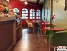 Cozy indoor cafe with artistic decor and wooden flooring