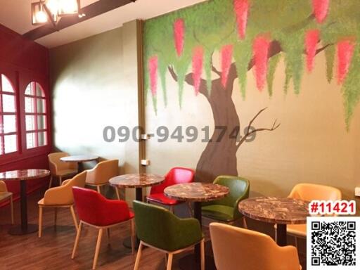 Cozy cafe interior with colorful chairs and artistic wall mural