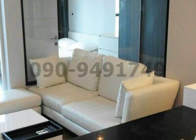 Modern living room with white sofa and dining area