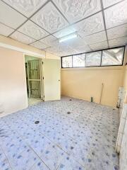 Empty interior room with tiled flooring and a decorative ceiling