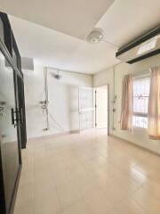 Spacious and well-lit living room with tile flooring