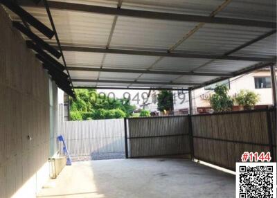 Spacious garage with a metal roof and cement flooring
