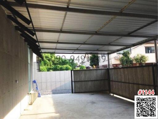 Spacious garage with a metal roof and cement flooring