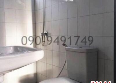 Bright bathroom with a toilet, sink, and shower