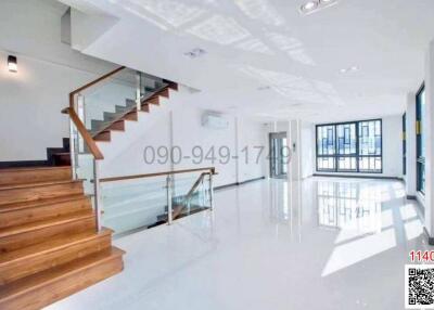 Spacious and bright interior with staircase and glossy floor finish