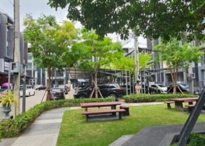 Well-maintained outdoor communal space with benches and greenery