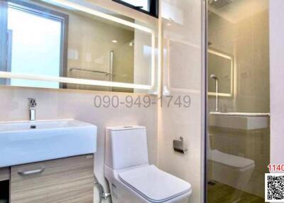 Modern well-lit bathroom with glass shower enclosure