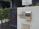 Exterior view of a modern residential building with mailboxes