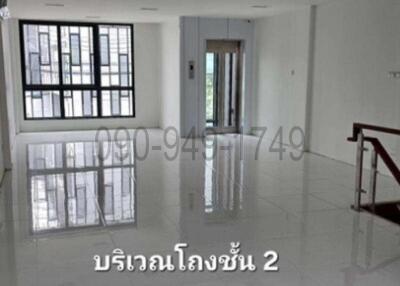 Spacious and well-lit empty room with glossy tiled floor and large windows