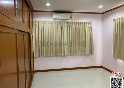 Spacious bedroom with air conditioning and built-in wooden wardrobe