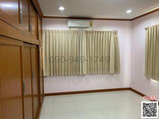 Spacious bedroom with air conditioning and built-in wooden wardrobe