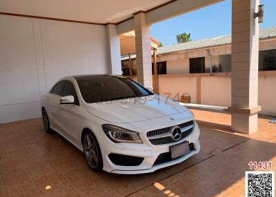 White car parked inside a residential garage with tiled flooring