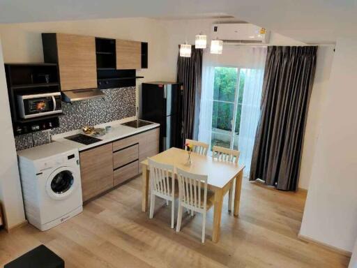 Modern kitchen with dining area and integrated appliances
