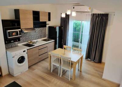 Modern kitchen with dining area and integrated appliances