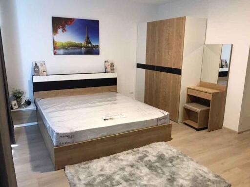 Modern bedroom with artwork and wooden furniture