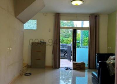 Bright and spacious living room with glossy tiled flooring and access to the balcony