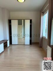 Spacious bedroom with large wardrobe and ample natural light