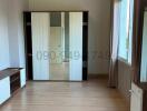 Spacious bedroom with large wardrobe and ample natural light