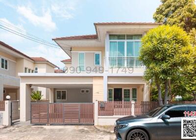 Modern two-story residential house with balcony and car park