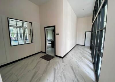 Bright and spacious entryway with large mirrors and marble flooring