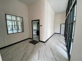 Bright and spacious entryway with large mirrors and marble flooring