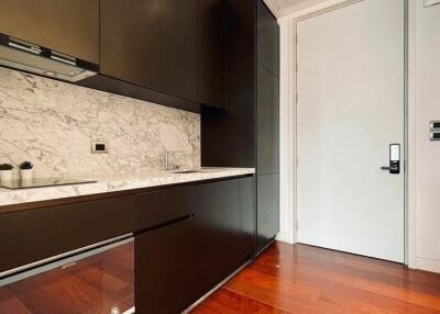 Modern kitchen with marble countertops and wooden floor