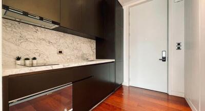 Modern kitchen with marble countertops and wooden floor