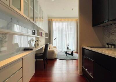 Modern kitchen with marble countertops and open plan view into living space