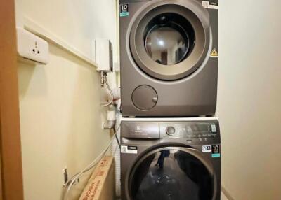 Stacked washer and dryer in a compact home laundry area