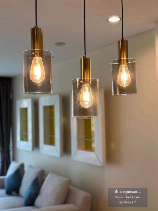 Stylish pendant lights with a cozy living room background
