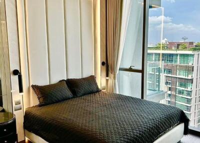 Contemporary bedroom with a large window and city view