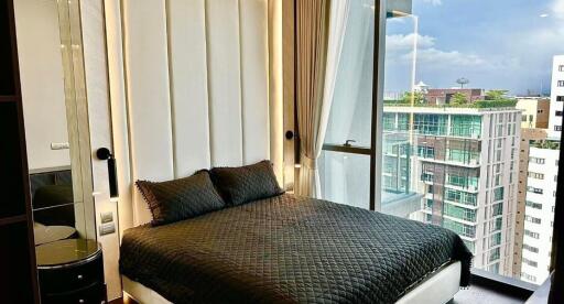 Contemporary bedroom with a large window and city view