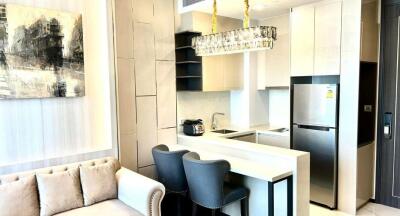 Modern kitchen with integrated living space including a seating area