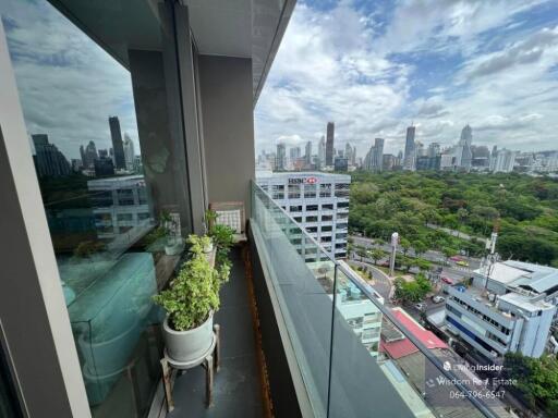 Balcony view overlooking the city with glass railing and potted plant