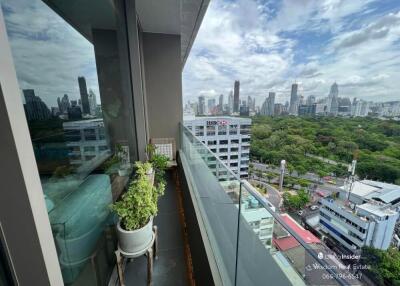 Balcony view overlooking the city with glass railing and potted plant