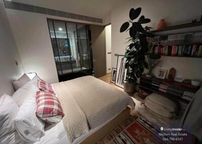 Cozy bedroom with bookshelf and large window