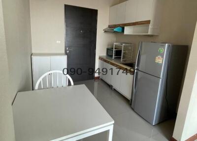 Compact kitchen with modern appliances and dining table