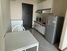 Compact kitchen with modern appliances and dining table