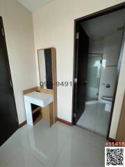 Hallway with a view into the bathroom, showing vanity and wardrobe