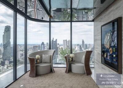 Elegant living room with panoramic city view through floor to ceiling windows