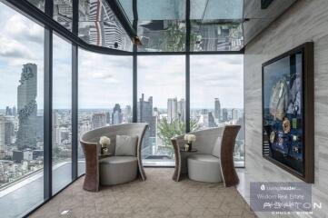 Elegant living room with panoramic city view through floor to ceiling windows