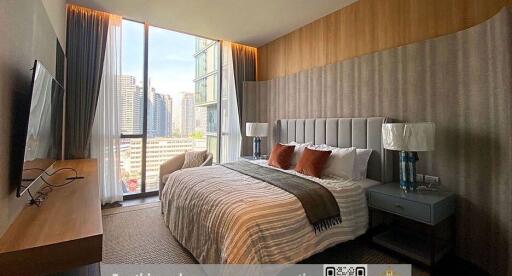 Modern bedroom with large windows and city view