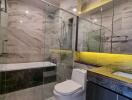 Modern bathroom with glass shower enclosure and marble finishes