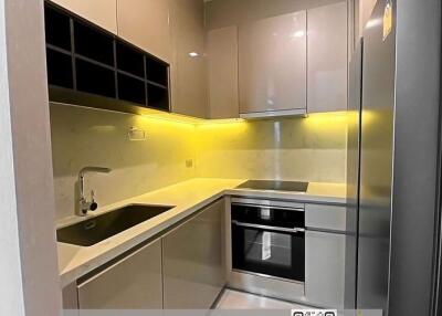 Modern kitchen with stainless steel appliances and LED lighting