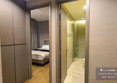 Cozy bedroom with en suite bathroom entry view