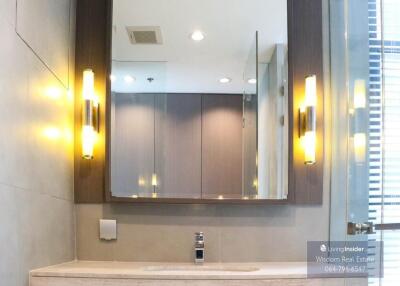 Modern bathroom interior with a well-lit vanity mirror and sink