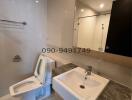 Modern bathroom with white ceramics and mirror