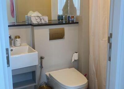 Modern bathroom with marble floor and well-lit vanity area