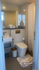 Modern bathroom with marble floor and well-lit vanity area